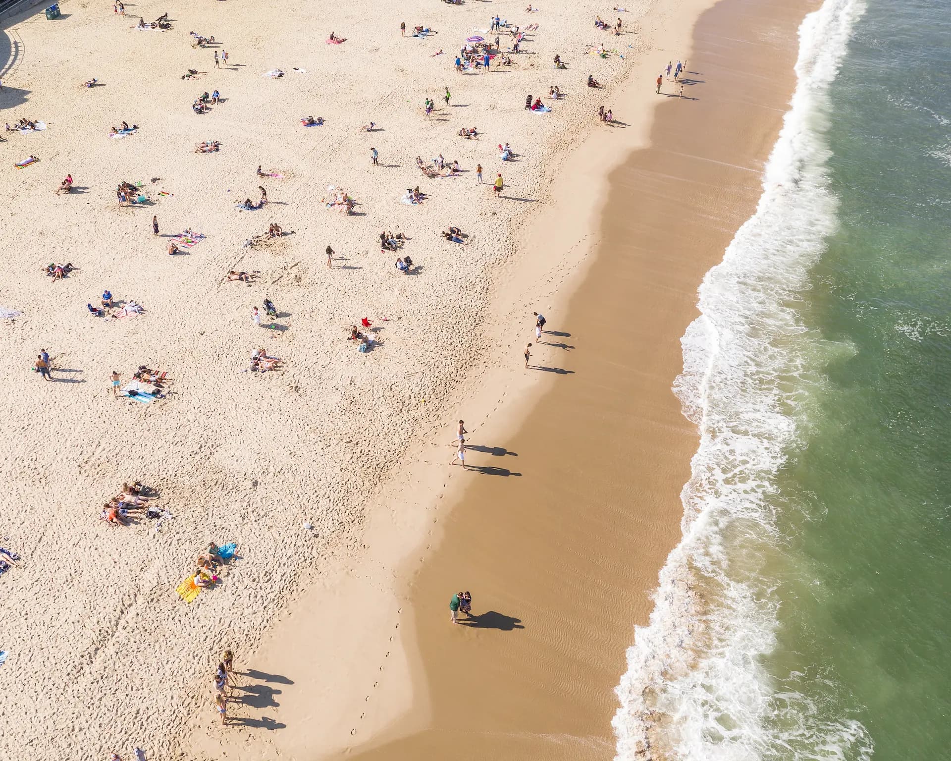 Aerial view of Long Branch beach with waves and beachgoers | Offsite Photography